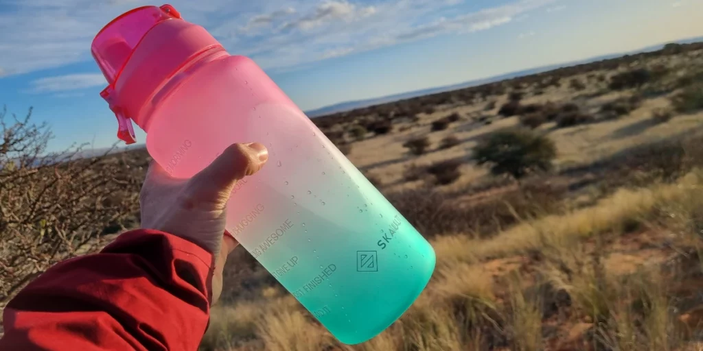 2L-Tritan-Water-Bottle-In-the-Bush-Protea-Fields.-Pink-Green